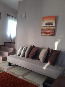 a living room with a couch with pillows on it at Modern Apartment in Melville, Pool View, 120 m² in Grande Gaube