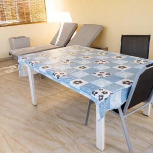 a blue and white table with four chairs around it at Elegant Apartment in Trou aux Biches / 125 m² / Mountain View in Trou aux Biches