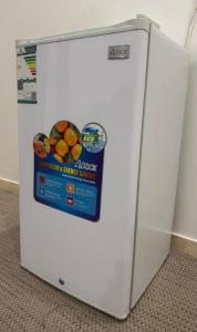 a white refrigerator with a box of fruit on it at استديو الراحه in Ash Shishah