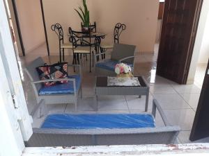 a living room with chairs and a table with a laptop at Appartement charmant à Sainte-Marie avec terrasse de 88 m² in Sainte-Marie