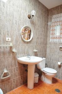 a bathroom with a sink and a toilet at Apartamentos Buen Leon in Playa de Tasarte