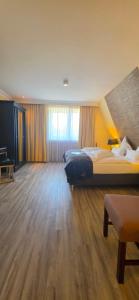 a large bedroom with two beds and a wooden floor at Business & More Boutique Hotel Hamburg in Hamburg +33 photos