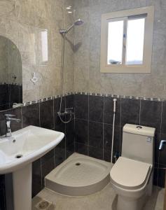 a bathroom with a toilet and a sink at استديو الراحه in Ash Shishah