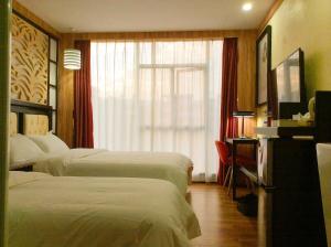Voodi või voodid majutusasutuse Guangzhou Bird Island Hotel toas