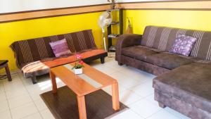 a living room with two couches and a coffee table at Appartement Privilégié Le Moule 70 m² + Piscine in Le Moule