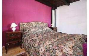 a bed in a bedroom with a pink wall at Charming Villa in Jezera with Private Pool in Jezera