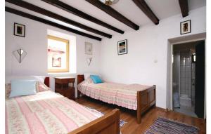 a bedroom with two beds and a window at Charming Villa in Jezera with Private Pool in Jezera