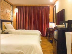 Voodi või voodid majutusasutuse Guangzhou Bird Island Hotel toas