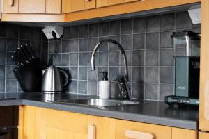 a kitchen counter top with a sink and aounter at Lake Cabin with Fireplace in Åre +13 photos