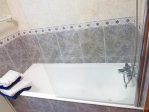 a bathroom with a white tub and a sink at Elegant Villa in Porto with Pool & Jacuzzi in Porto +39 photos