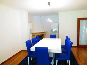 a conference room with a white table and blue chairs at Elegant Villa in Porto with Pool & Jacuzzi in Porto
