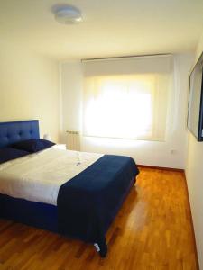 a bedroom with a large bed and a window at Elegant Villa in Porto with Pool & Jacuzzi in Porto