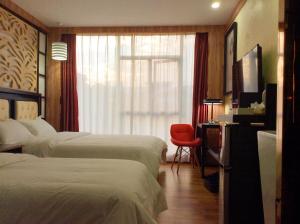 Voodi või voodid majutusasutuse Guangzhou Bird Island Hotel toas