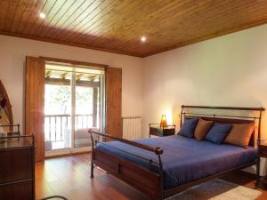 a bedroom with a bed with a wooden ceiling at Elegant Villa with Panoramic Views in Caniçada in Caniçada