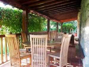 a wooden table and chairs under a wooden pergola at Elegant Villa with Panoramic Views in Caniçada in Caniçada