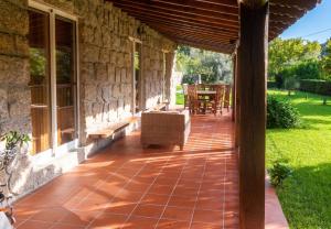 an outside patio with a chair and a table at Elegant Villa with Panoramic Views in Caniçada in Caniçada