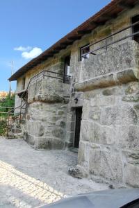 a stone building with a door on the side of it at Cozy house in Águeda 45 m² with shared pool in Urgueira +38 photos