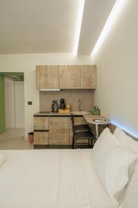 a bedroom with a bed and a kitchen with a table at Dreamscape Central in Tirana