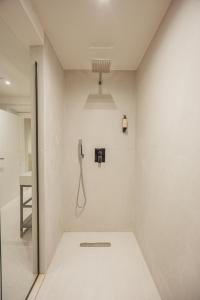 a shower room with a phone on the wall at Dreamscape Central in Tirana