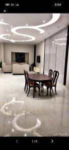 a table and chairs in a room with a couch at ريفون in Tabuk