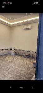 an empty room with a row of chairs and a radiator at ريفون in Tabuk