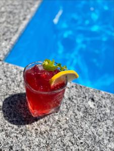 a drink sitting on a table next to a pool at IVERIA BEACH in Kobuleti