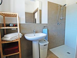 a bathroom with a sink and a shower at Charming House in Is Potettus with Private Garden in SantʼAnna Arresi