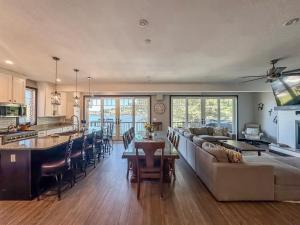 a living room and kitchen with a couch and a table at New Luxury Lakefront Walk to Wisp in McHenry