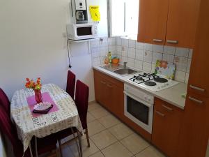 a small kitchen with a table and a stove top oven at Charming Apartment in Pag with Sea View, 40 sqm in Pag