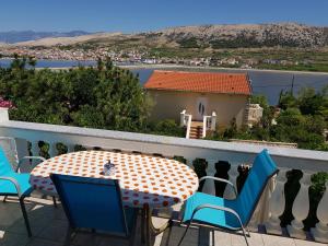 a table and chairs on a balcony with a view at Charming Apartment in Pag with Sea View, 40 sqm in Pag +27 photos