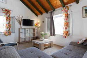 a living room with a couch and a table at Charming Villa in Pučišća + Pool in Pučišća