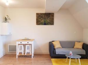 a living room with a couch and a table at Charmant studio à Abondant avec terrasse ensoleillée - 30 m² in Abondant