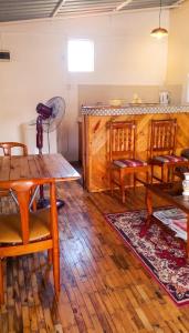 a dining room with wooden floors and a table and chairs at Charming studio with sea-view terrace in Souillac - 22 m². in Souillac