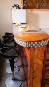 a table with a counter with a row of stools at Charming studio with sea-view terrace in Souillac - 22 m². in Souillac +13 photos