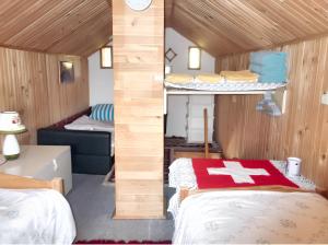 a small room with two beds and a room with at Cozy House in Jazvine with Garden in Jazvine