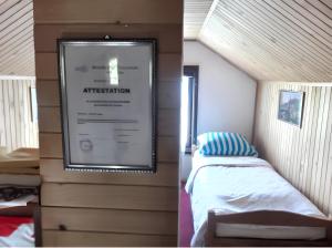 a small bedroom with a bed and a large screen at Cozy House in Jazvine with Garden in Jazvine +8 photos