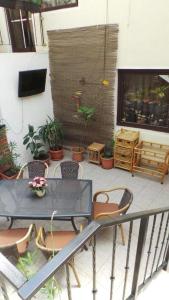 a balcony with a table and chairs on a patio at Spacious chalet in Sibiel with mountain and lake views + Jacuzzi in Sibiel