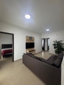 a living room with a couch and a fireplace at Casa Completa em Picarras, Piscina, Sinuca e Churrasqueira in Piçarras +26 photos