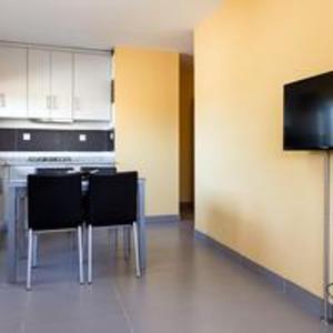 a kitchen with a table and some black chairs at Comfortable Bungalow Pinhel, pool in Pinhel