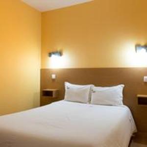 a bedroom with a large white bed with two pillows at Comfortable Bungalow Pinhel, pool in Pinhel