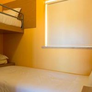 a bedroom with a bed and a window in it at Comfortable Bungalow Pinhel, pool in Pinhel +4 photos