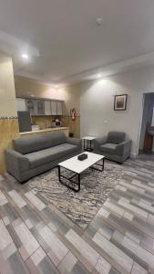 a living room with two couches and a coffee table at Dar Karim in Abha