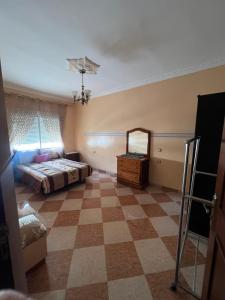 a bedroom with a bed and a dresser and a mirror at Hrich house in Fnidek
