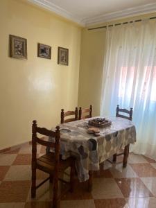 a room with a table and two chairs and a window at Hrich house in Fnidek