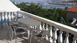 a white table and chairs on a balcony at Cosy apartment in Pag / 26 m² / Sea view in Pag +16 photos