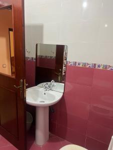 a bathroom with a sink and a red wall at Hrich house in Fnidek