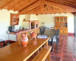 a kitchen with a table with vases on it at Welcoming villa in Santa Leocádia, private pool 475 m² in Feijoal