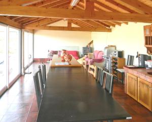 a large dining room with a long table and chairs at Welcoming villa in Santa Leocádia, private pool 475 m² in Feijoal
