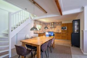 a kitchen with a wooden table and chairs at Strandhuys Oester in De Koog