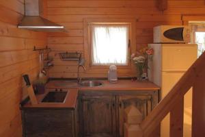 a small kitchen with a sink and a refrigerator at Charming bungalow in Tarifa with mountain view and garden in Tarifa